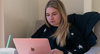 An image of a woman on her laptop. 